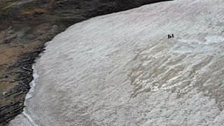 Scientists study an ice patch on the Beartooth Plateau in the Greater Yellowstone Ecosystem ( aerial view)