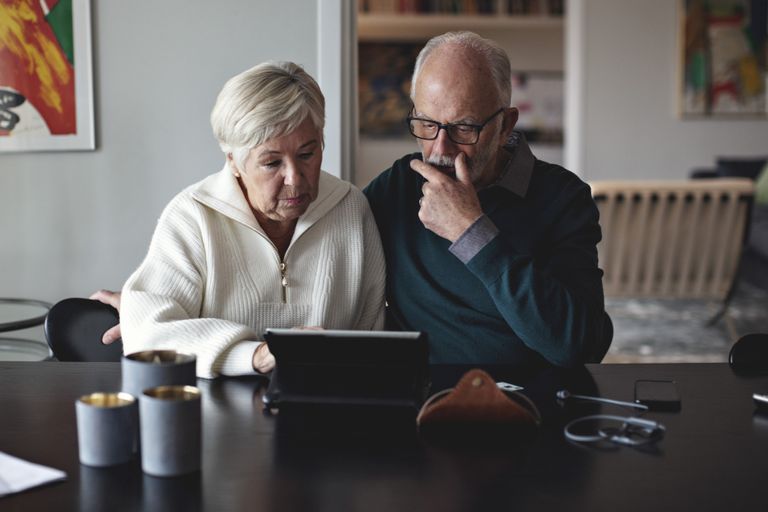 elderly couple using digital tablet