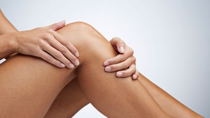 woman touching legs - best instant tan