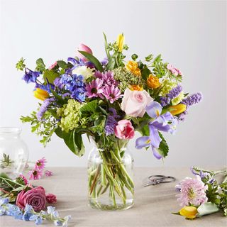 A Spring Tradition bouquet on a wooden table