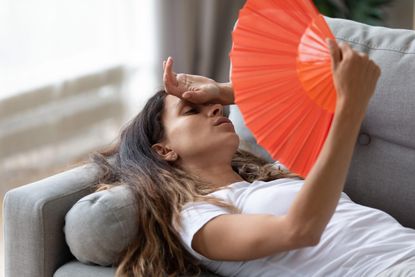 Exhausted woman suffering with heat exhaustion