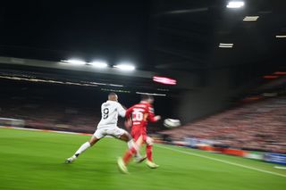 Kylian Mbappe of Real Madrid in action with Andrew Robertson of Liverpool during the UEFA Champions League 2024/25 League Phase MD5 match between Liverpool FC and Real Madrid C.F. at Anfield on November 27, 2024 in Liverpool, England.