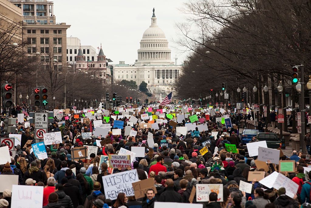 Demonstrators march down Pennsylvania Avenue during a protest of President Trump&#039;s travel ban on Jan. 29, 2017 in Washington, D.C. 