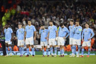 Manchester City players look on after their UEFA Champions League exit.