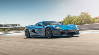 A Rimac Nevera driving on a road in summer