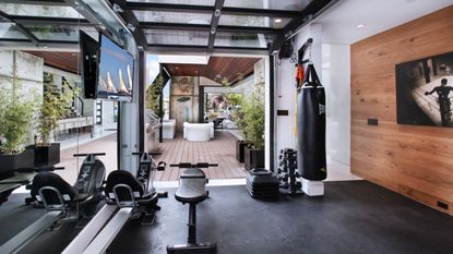 A garage gym conversion overlooking a decked outdoor area