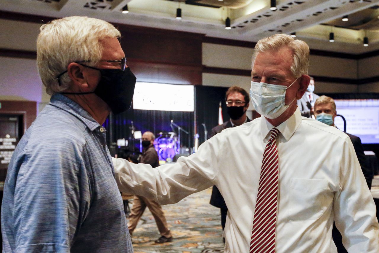 Tommy Tuberville, right, speaks with a supporter.