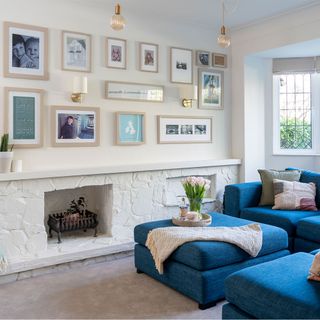 white living room with stone fireplace and blue sofa