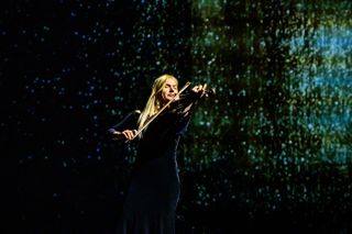 Violinist Joanna Kaczorowska plays music on stage for a moment in the May 22 production of "Light Falls: Space, Time, and an Obsession of Einstein" in New York City.