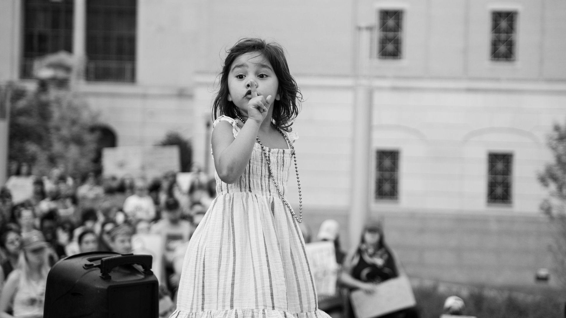 Lily, at the Nashville rally, shushing the crowd so her mother can speak.