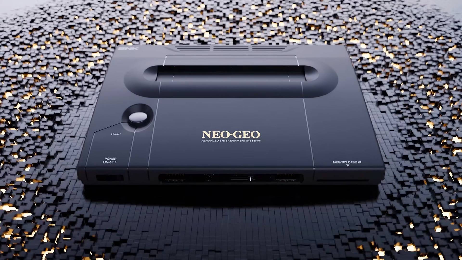 Neo Geo AES+ console in black sitting on fragmented surface made of black cubes.