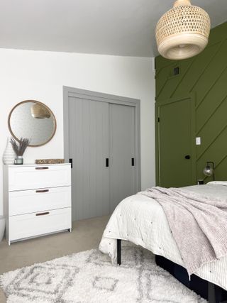 An IKEA PAX wardrobe painted grey in a modern bedroom
