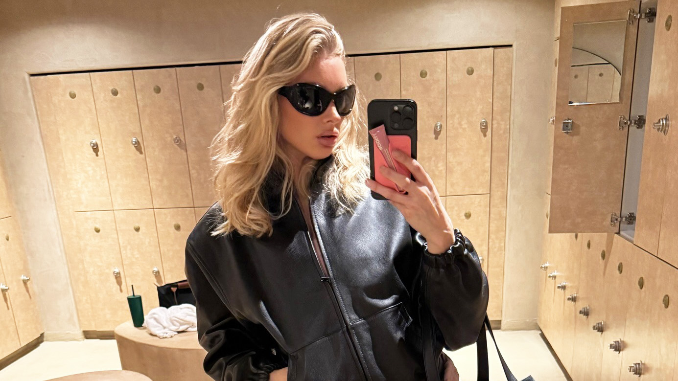 Elsa Hosk wearing a black leather jacket, pink Alo shorts, and pink cap-toe Chanel ballet flats.