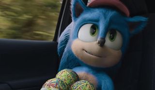Sonic The Hedgehog smiling, with several rubber band balls in his arms
