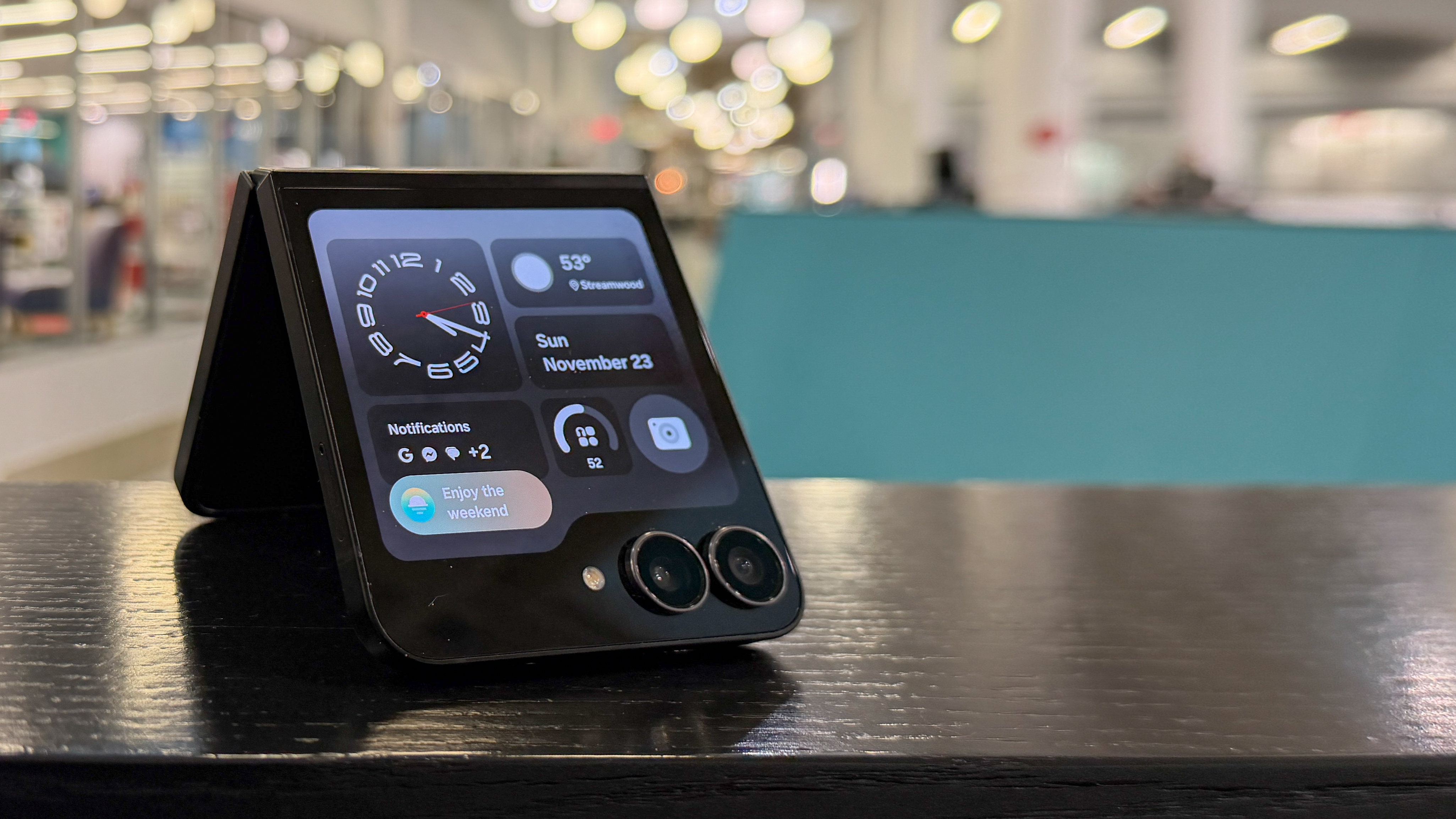 Samsung Galaxy Z Flip 7 FE in piano black color showing content on the cover display and the main screen