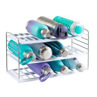 A white and metal rack of blue and purple water bottles in various designs and patterns