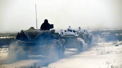 Ukrainian servicemen on armed vehicles