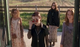 The Craft witches trying to get on a bus near a farm