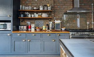 anthracite grey kitchen cabinets with exposed brick wall and open shelving