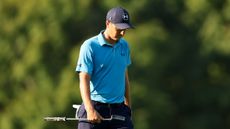 Jordan Spieth walking with his head down and putter in hand during a PGA Tour event