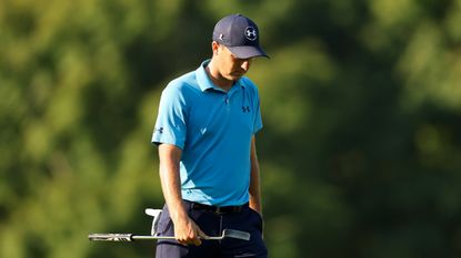 Jordan Spieth walking with his head down and putter in hand during a PGA Tour event