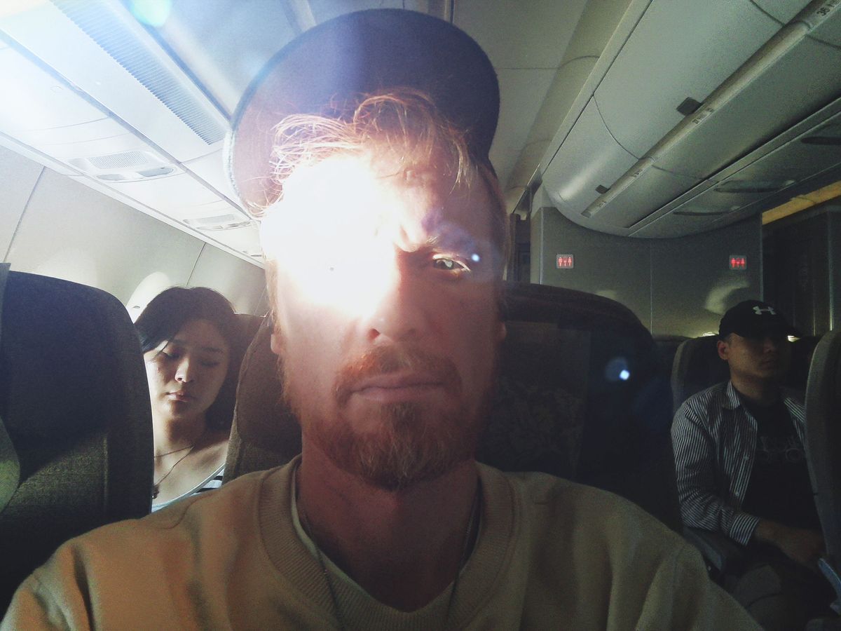 Fujifilm Instax Pal 2 sample gallery: selfie of a man seated in an airplane, his face is brightly illuminated by sunlight