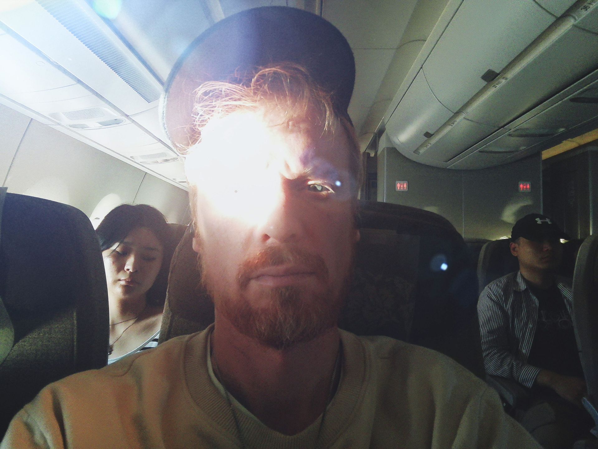 Fujifilm Instax Pal 2 sample gallery: selfie of a man seated in an airplane, his face is brightly illuminated by sunlight