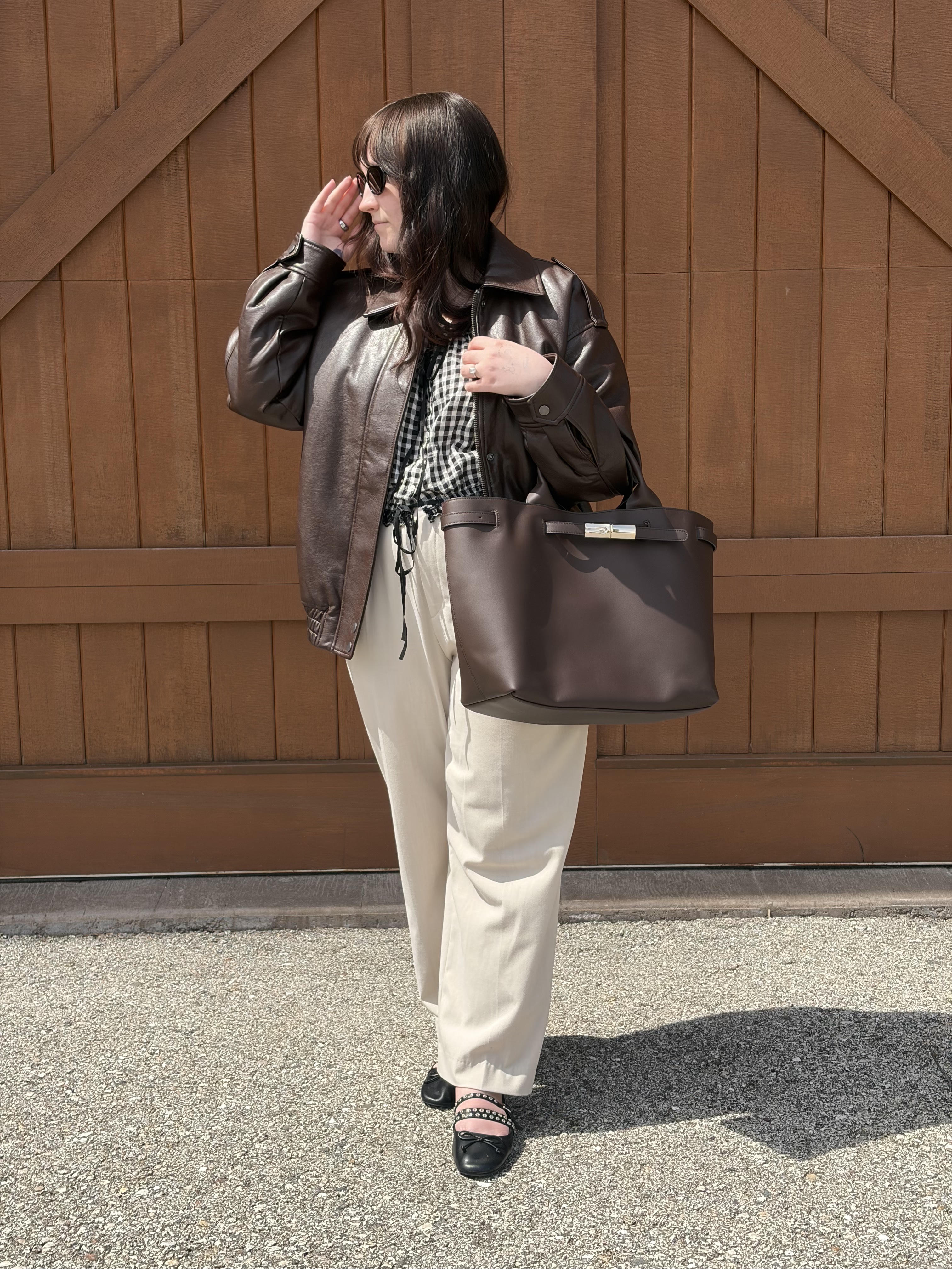 Meguire Hennes carrying Longchamp Le Smart bag with work outfit
