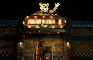 Five Nights at Freddy's cast: Freddy Fazbear stands outside the pizzeria with a young child.