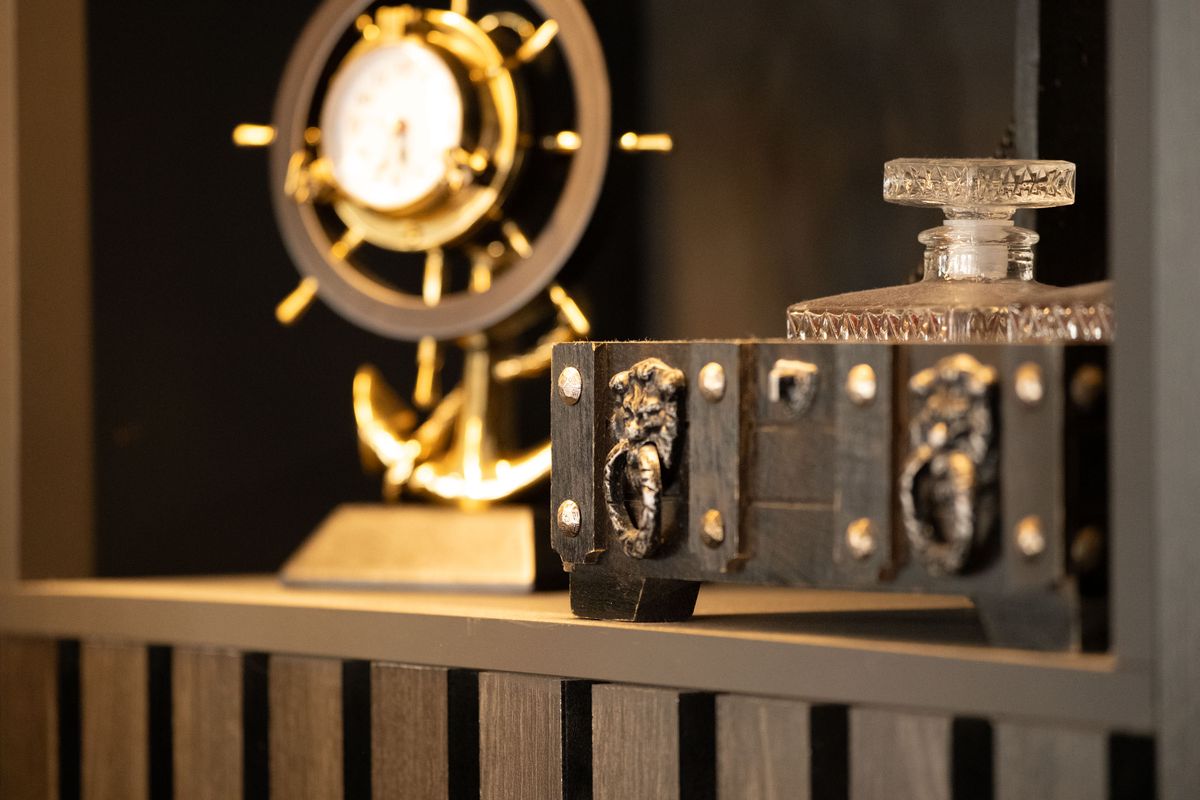 Viltrox AF 90mm F2.2 EVO lens image gallery: a wooden box with brass clasps and a shipping clock on a wooden shelf