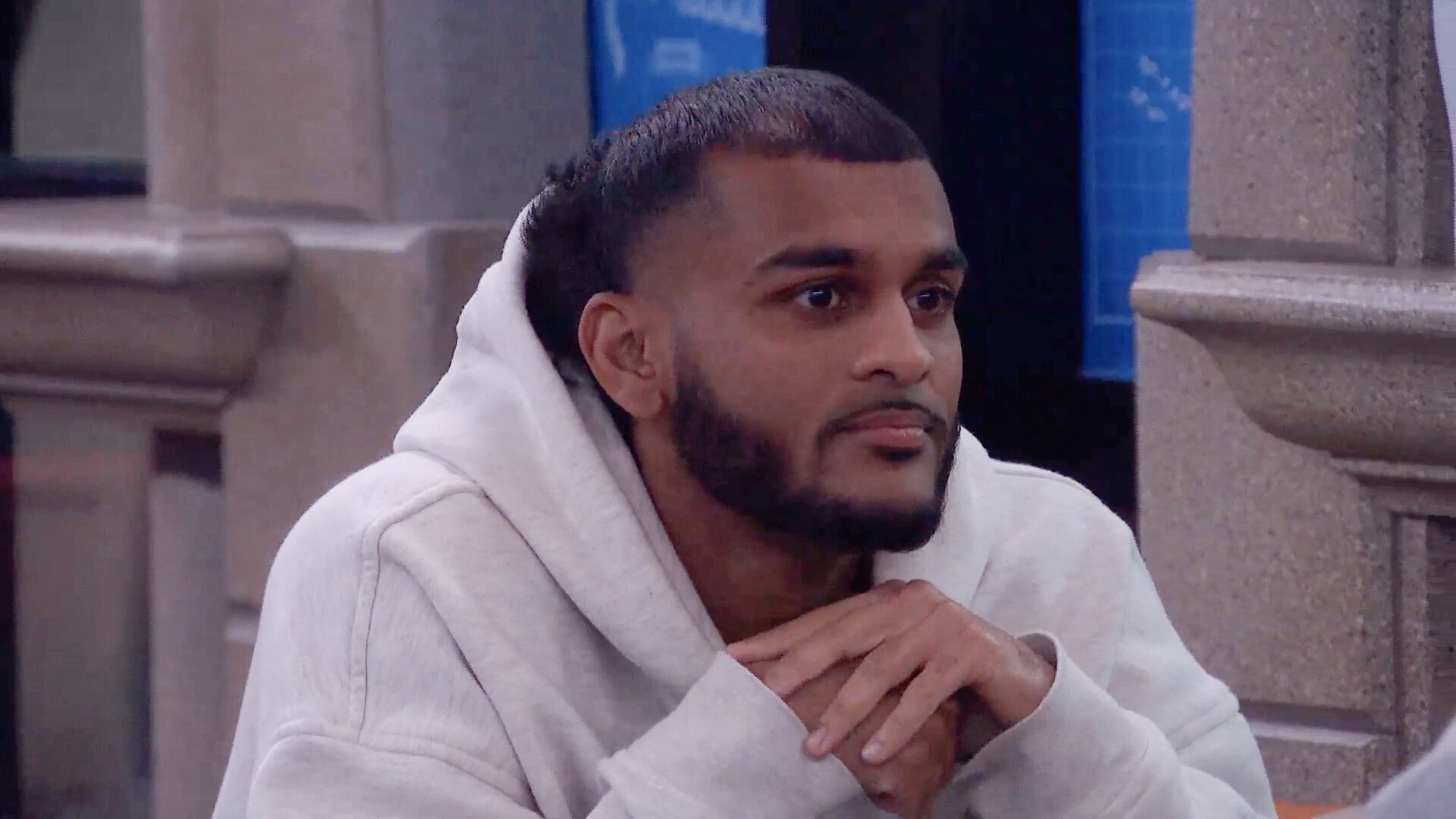 Yash with his hands under his chin.