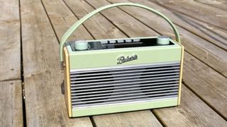 The Roberts Rambler DAB Radio outside on a wooden table.