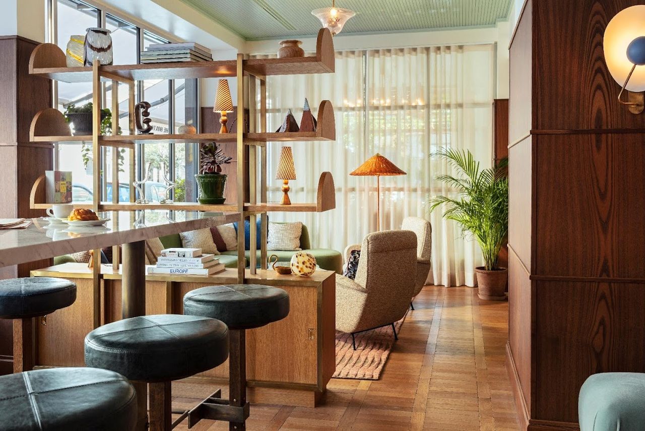An imaginatively decorated Roman hotel features a green and brown colo scheme, whimsical furniture, and lots of leather accents.