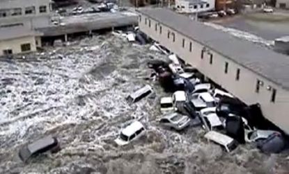 Cars collect at the side of a building as tsunami waves ravage Japan's Kesennuma port earlier this month.