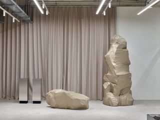 Close up view of steel stands and large faux stones made from Styrofoam in a store in Stuttgart designed by Vaust studio