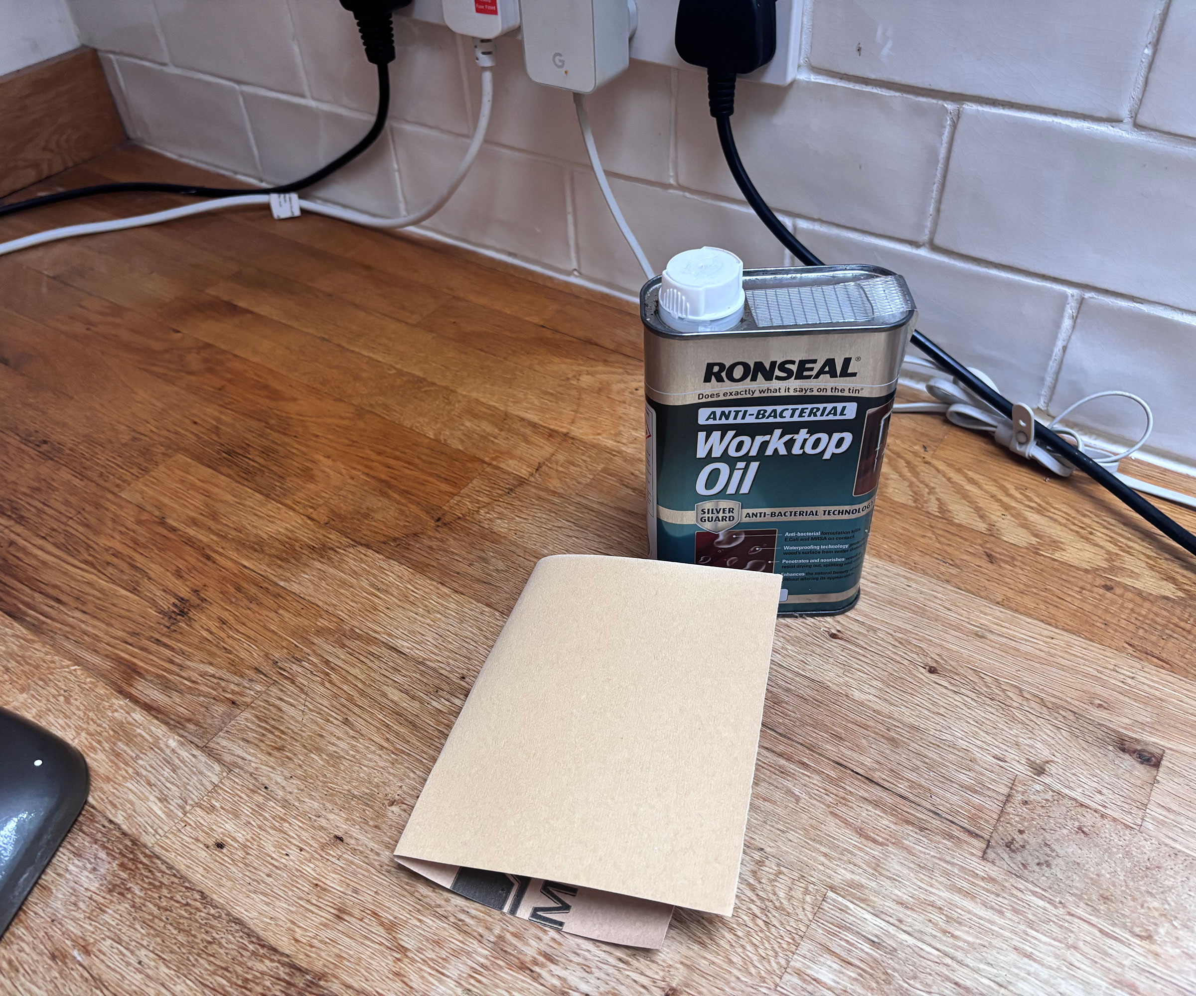 Ronseal worktop oil and sandpaper on wooden worktop