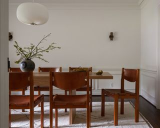 neutral dining room with wooden chairs