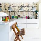 kitchen with pedant light wooden chair and wallpaper