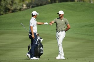 Day fist bumps Schauffele whilst withdrawing