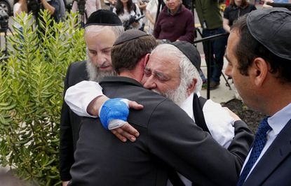 Rabbi Yisroel Goldstein hugs a congregant.
