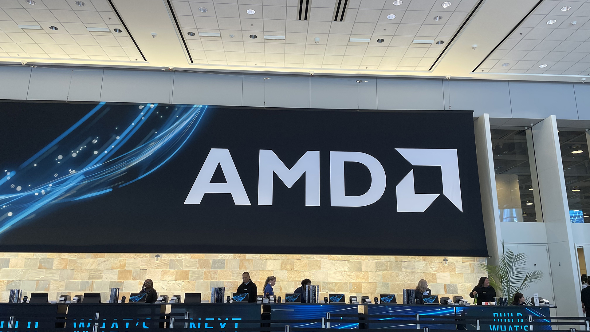 A large banner with the AMD logo on it above the registration desk at AMD Advancing AI 2026