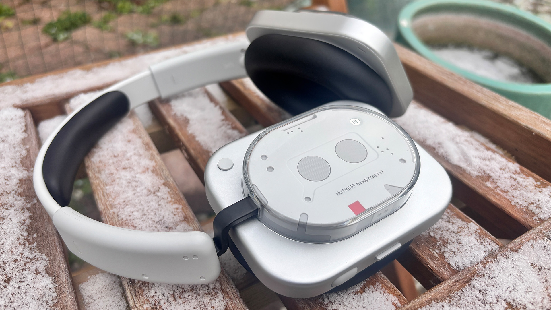 Nothing Headphone (1) wireless headphones on snowy wooden garden chair