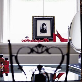 room with photo frame and red heels