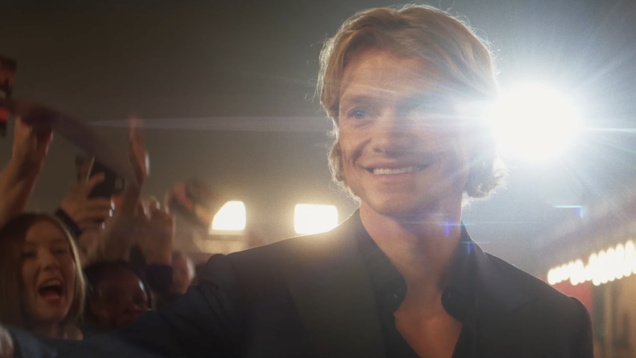 Matt Hagen, pre-attack, walking red carpet in front of screaming fans and theater lights in Clayface