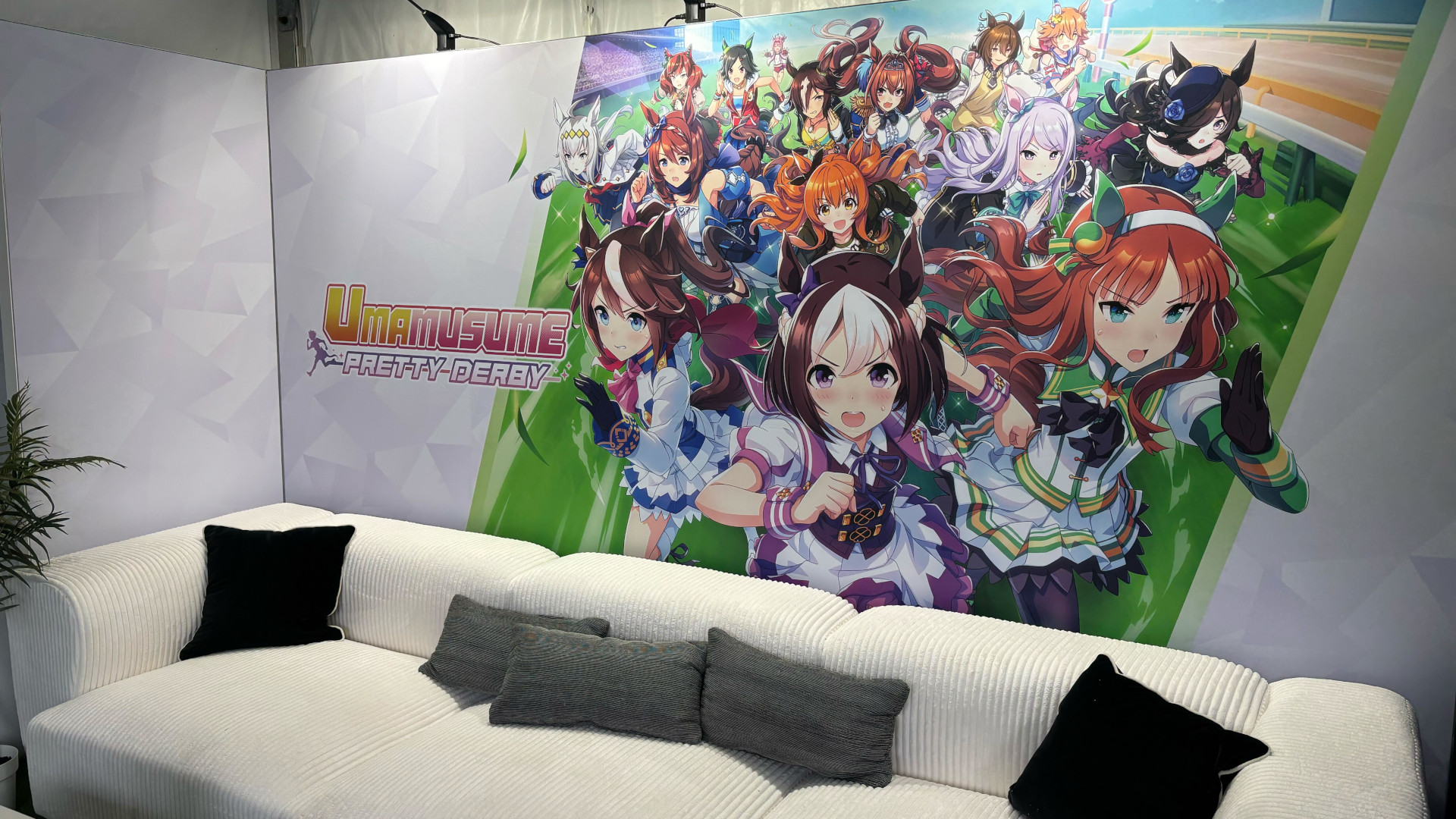 A photo from the 2025 Kentucky Derby's Umamusume: Pretty Derby booth showing a big comfy couch for event goers to relax upon while they ponder all things Umamusume