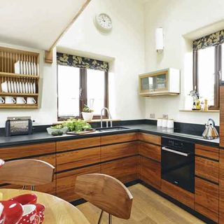 kitchen with black counter and wooden drawers