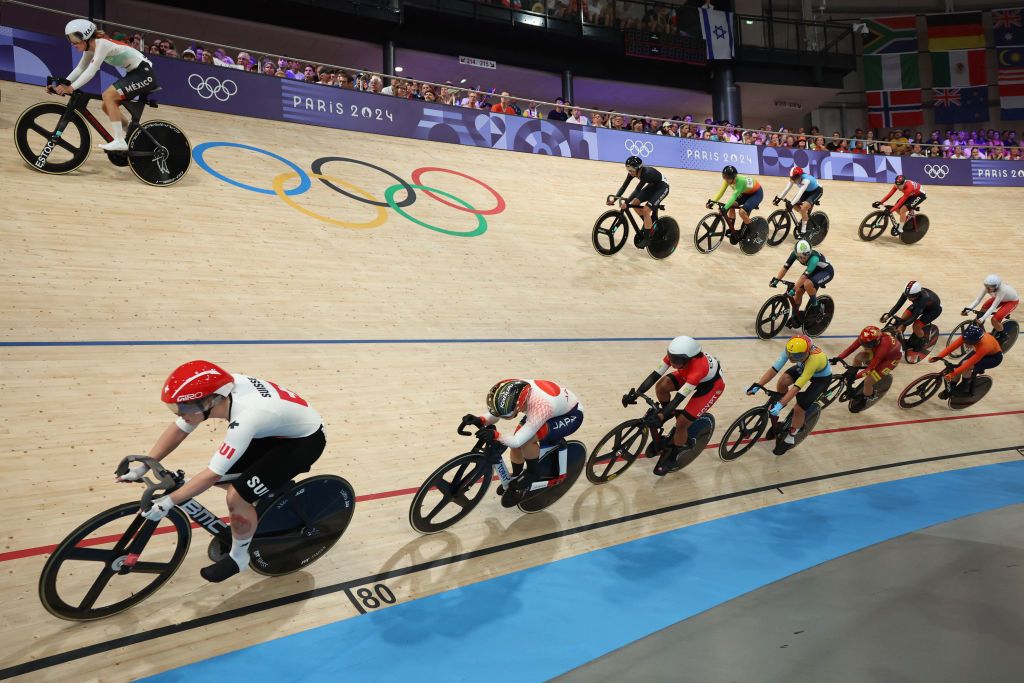 Riders compete in the women's track cycling omnium scratch race of the Paris 2024 Olympic Games at the Saint-Quentin-en-Yvelines National Velodrome in Montigny-le-Bretonneux, south-west of Paris, on August 11, 2024. (Photo by Emmanuel DUNAND / AFP)