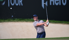 Rory McIlroy hits a bunker shot