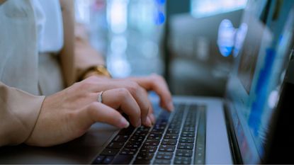 photo of hands in front of computer screen