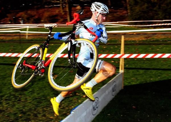 Adam Myerson (Cycle-Smart) sprinting over the barriers.